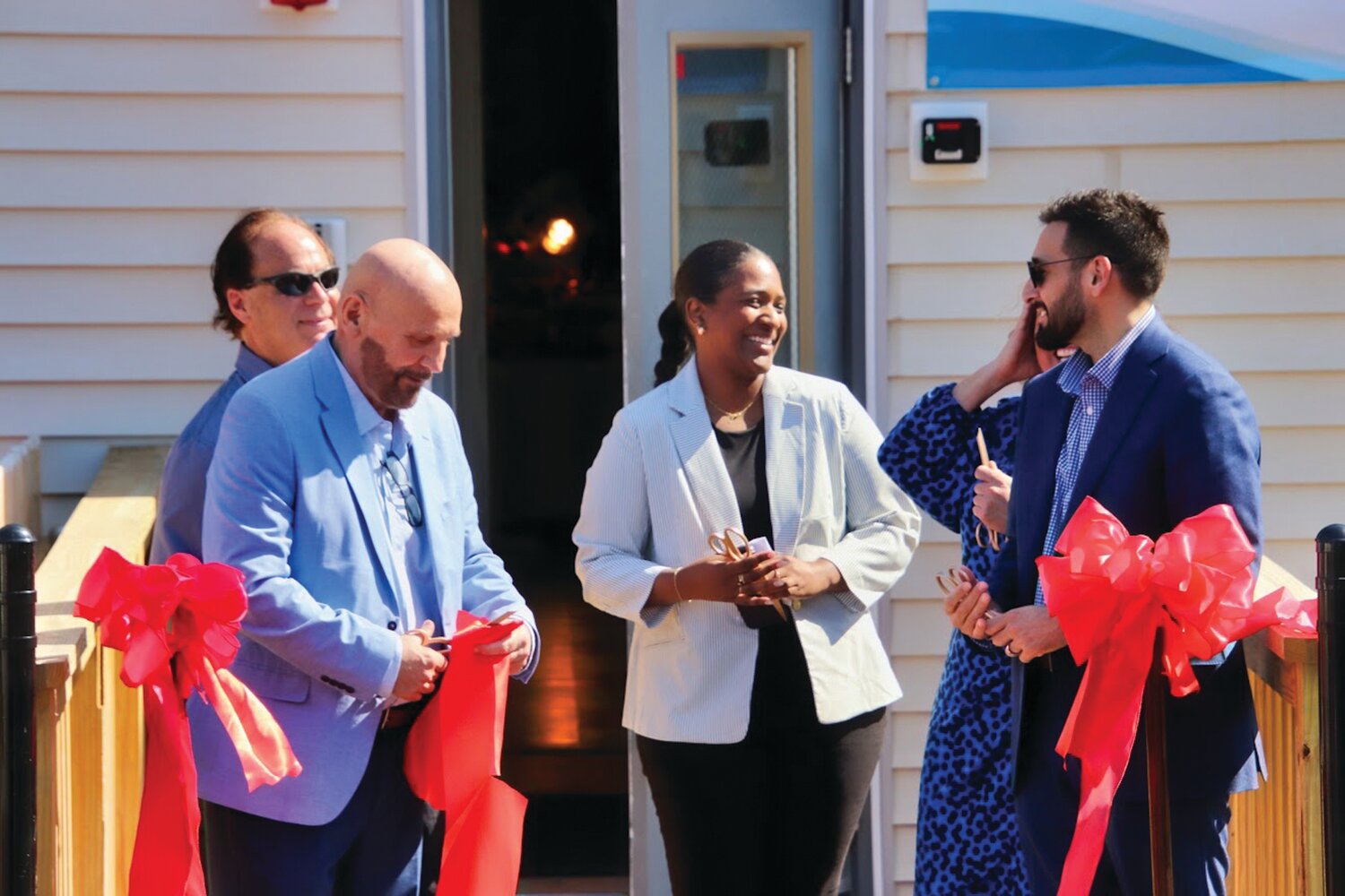HEZ DISPENSER: Tri-County Community Action Agency snipped the ribbon on a new Health Equity Zone (HEZ) Community Center at 104 Greenville Ave. in Johnston. From left to right, Tri-County President and CEO Joseph DeSantis, Johnston Town Council member Alfred T. Carnevale, Nadine Tavares, lead HEZ initiative project officer with the Rhode Island Department of Health, HEZ Director Lisa Kennedy, and Johnston Mayor Joseph Polisena Jr. helped cut the ribbon on the new center. (Photos courtesy Tri-County)